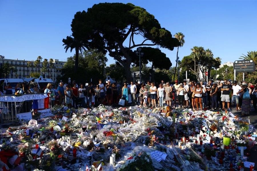 Associated Press People gather at a makeshift memorial Sunday to honor the victims of a truck attack on revelers on the famed Promenade des Anglais in Nice southern France. French authorities detained two more people Sunday in the investigation