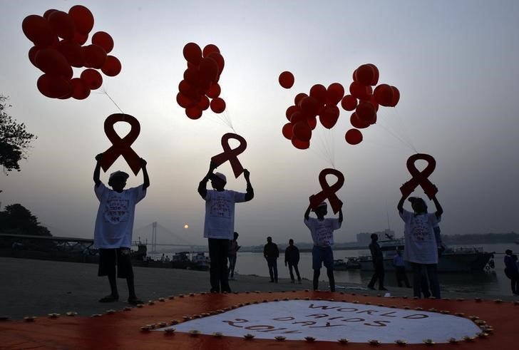 Children display ribbon cut-outs tied to balloons during an HIV  AIDS awareness campaign to mark World AIDS Day in Kolkata