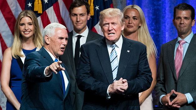 Newly selected vice presidential running mate Mike Pence governor of Indiana stands onstage with Republican presidential candidate Donald Trump and the Trump family at the end of an event at the Hilton Midtown Hotel