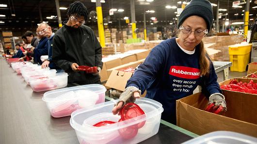 Employees assemble food containers on a production line at the Newell Rubbermaid factory in Mogadore Ohio