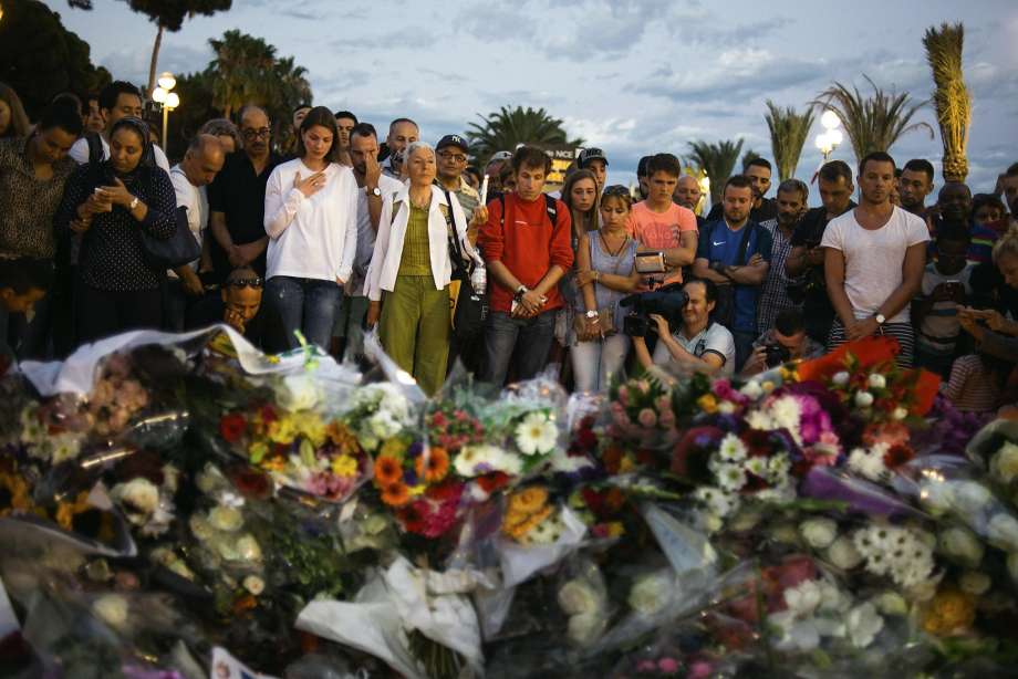 People mourn at a makeshift memorial on the Promenade des Anglais in Nice where a man drove a 19-ton truck through the Bastille Day fireworks crowds killing 84 and leaving hundreds more wounded