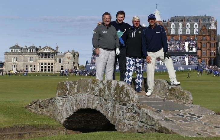 Tony Jacklin of England poses with compatriot Nick Faldo, John Daly of the U.S. and his compatriot Tom Lehman as they stand on the Swilcan Bridge on the 18th hole during the Champion Golfers Challenge tournament ahead of the British O