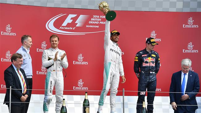 Mercedes AMG Petronas F1 Team's British driver Lewis Hamilton celebrates on the podium after the British Formula One Grand Prix at Silverstone motor racing circuit in Silverstone central England