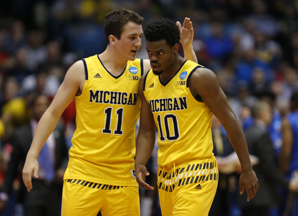 Mar 16 2016 Dayton OH USA Michigan Wolverines guard Andrew Dakich and guard Derrick Walton Jr. celebrate during the second half against the Tulsa Golden Hurricane in the First Four of the NCAA men's college basketball tournament at Day