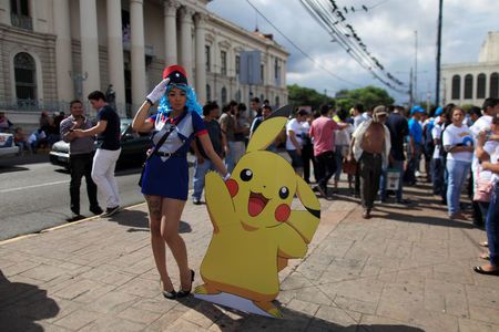 Cosplayer dressed as a character of the augmented reality mobile game'Pokemon Go by Nintendo participate in a'poketour organized by the municipality in San Salvador El Salvador