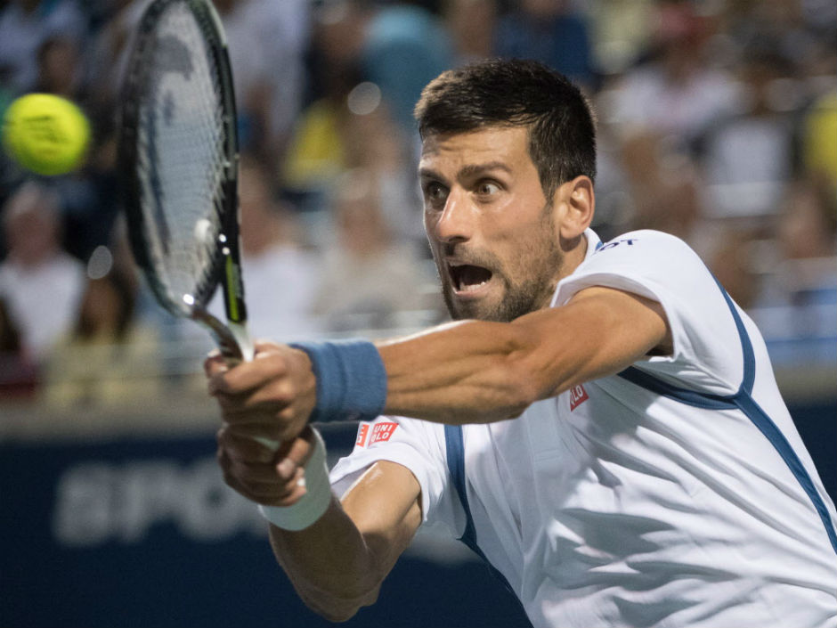 Novak Djokovic of Serbia returns the ball against Gael Monfils of France during men's semifinal action at the Rogers Cup in Toronto on Saturday night