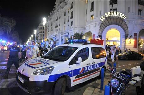 A Police car is parked near the scene of an attack after a truck drove on to the sidewalk and plowed through a crowd of revelers who'd gathered to watch the fireworks in the French resort city of Nice southern France Friday