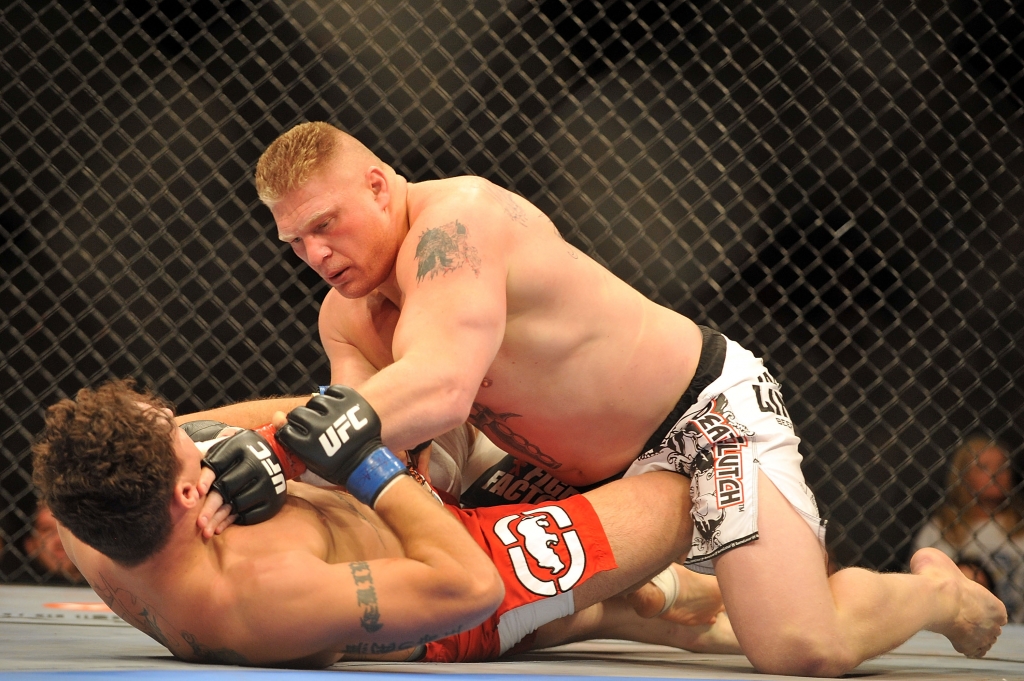 LAS VEGAS- JULY 11 Brock Lesnar holds down Frank Mir during their heavyweight title bout during UFC 100