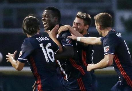 New England Revolution midfielder Je Vaughn Watson second from left celebrates his goal with teammates Daigo Kobayashi, Diego Fagundez third from left and Steve Neumann far right during a U.S. Open Cup soccer match against the Philadelphia Union