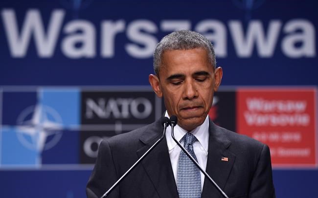 President Barack Obama pauses while speaking about the events in Dallas at the beginning of his news conference at PGE National Stadium in Warsaw Poland Saturday