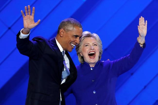 President Barack Obama and Democratic Presidential nominee Hillary Clinton wave to delegates after President Obama's speech during the third day of the Democratic National Convention in Philadelphia, Wednesday