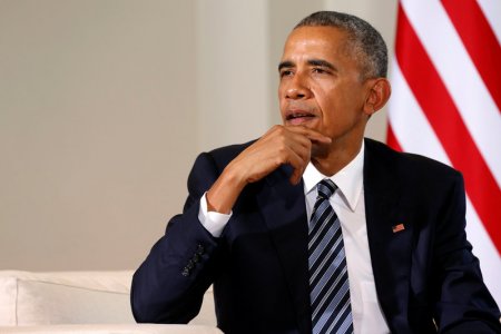 U.S. President Barack Obama answers a reporter's questions after meeting with Spain's acting Prime Minister Mariano Rajoy at the Palacio de la Moncloa in Madrid Spain