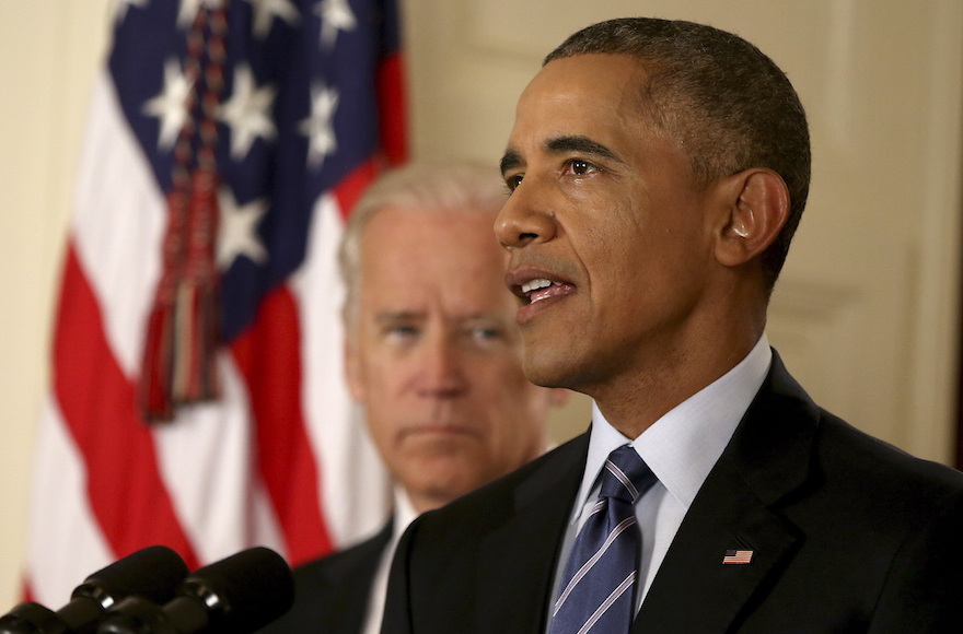 President Barack Obama standing with Vice President Joe Biden conducts a press conference in the East Room of the White House in response to the Iran Nuclear Deal