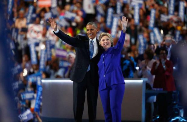 U.S. President Barack Obama and Democratic presidential candidate Hillary Clinton wave to the crowd after the President spoke at the Democratic National Convention in Philadelphia. Reuters