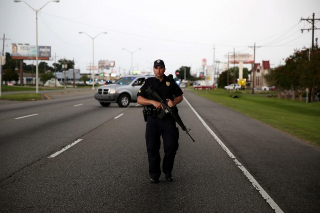 A police officer blocks off a road near the scene of a fatal shooting of police officers in Baton Rouge Louisiana United States