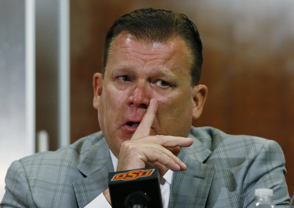 Oklahoma State basketball coach Brad Underwood fights back tears at a news conference in Stillwater Okla. Friday