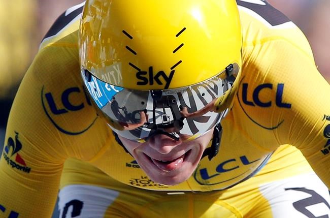 Britain's Chris Froome wearing the overall leader's yellow jersey crosses the finish line to win the eighteenth stage of the Tour de France cycling race an individual time trial over 17 kilometers with start in Sallanches and finish