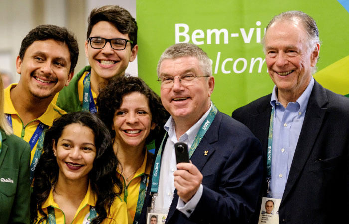 Thomas Bach, President of the International Olympic Committee, looks at a 360-degree camera given by an official videographer upon his arrival for Rio 2016 Olympic games at Antonio Carlos Jobim International Airport in Rio de Janeir