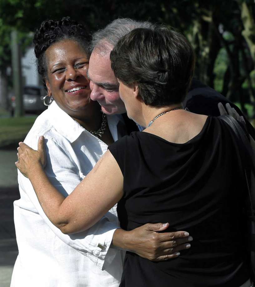 A fellow parishoner left of St. Elizabeth's Catholic Church in Richmond Va. greets Sen. Tim Kaine center and his wife Anne Holton as they arrive for Mass at St. Elizabeth Catholic Church their longtime parish Sunday