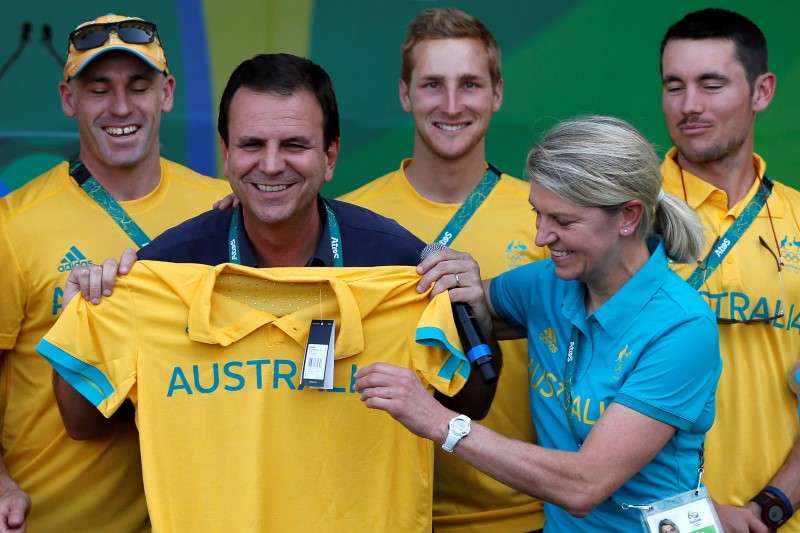 Kitty Chiller Chef de Mission for Australia at the Rio 2016 Olympic Games gives Australia t-shirt to Rio's mayor Eduardo Paes during a welcome ceremony he arranged for them at the Olympic village in Rio de Janeiro Brazil