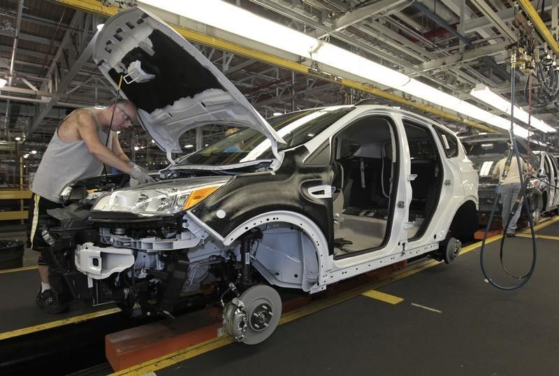 Plant employees assembling the 2013 Ford Escape on the production line in Louisville