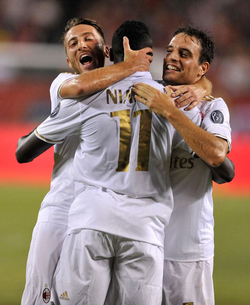 AC Milan's M'baye Niang celebrates with teammates Andrea Bertolacci left and Giacomo Bonaventura right after scoring a goal against Bayern Munich during their match Wednesday in Chicago