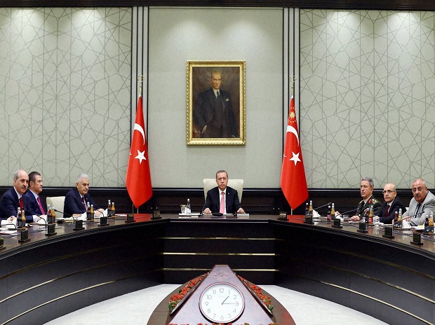 Turkey's President Recep Tayyip Erdogan centre heads an emergency meeting of the National Security Council with Prime Minister Binali Yildirim center left Chief of Staff Gen. Hulusi Akar center right and ministers in Ankara Turkey Wednesday