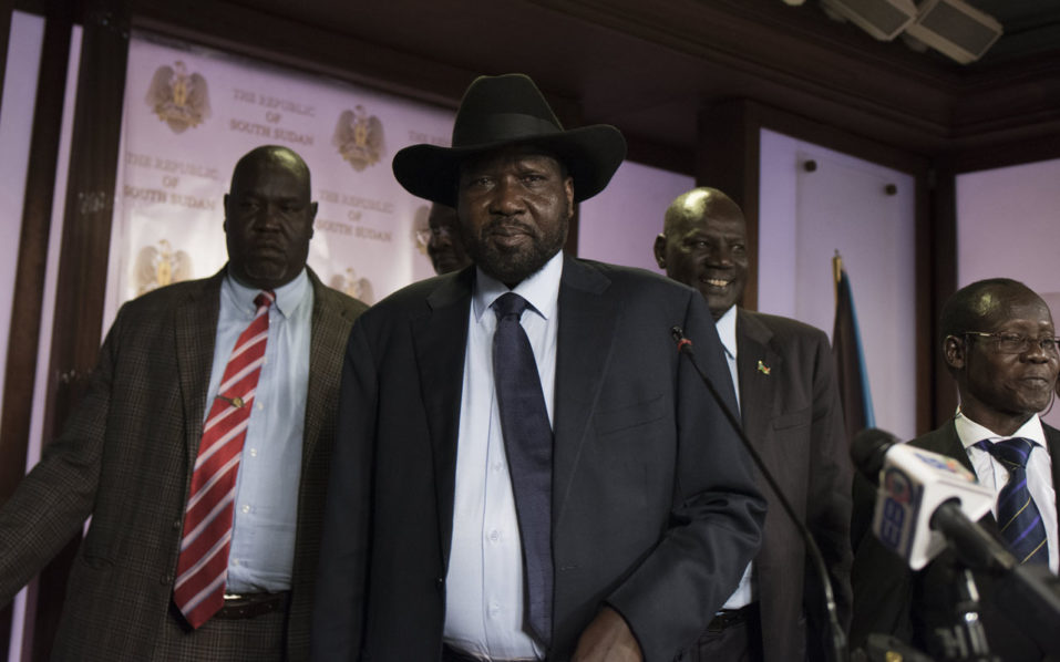 South Sudan President Salva Kiir, followed by Vice President James Wani Igga, leaves the conference room as artillery fire broke out near the presidential palace in Juba