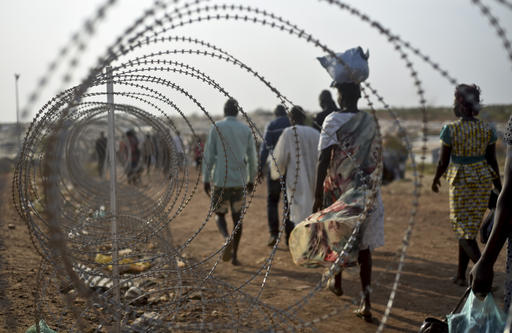 19 2016 displaced people walk next to a razor wire fence at the United Nations base in the capital Juba South Sudan. South Sudanese government soldiers raped dozens of eth