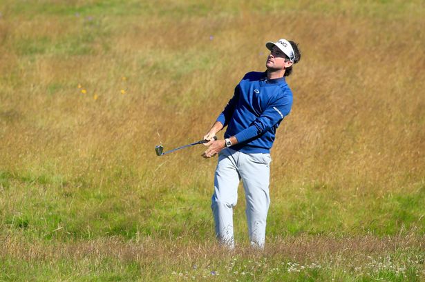 Bubba Watson plays out of the rough on the first hole