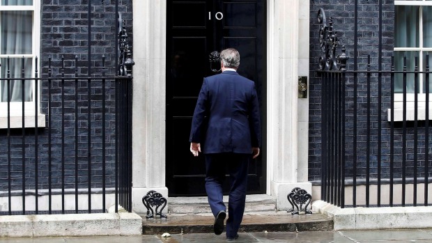 Britain's Prime Minister David Cameron returns to 10 Downing Street