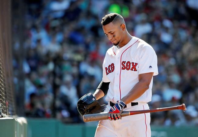 Boston Red Sox's Xander Bogaerts walks back to the dugout after striking out in the ninth inning of a baseball game against the Detroit Tigers at Fenway Park Wednesday