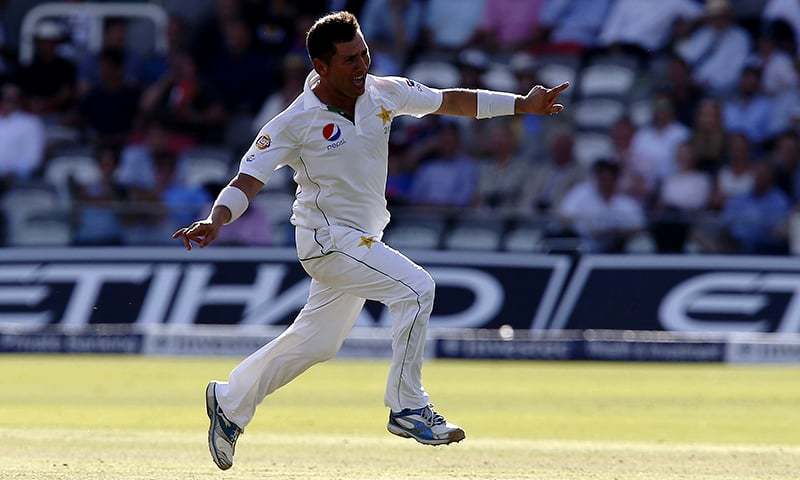 Pakistan's Yasir Shah celebrates taking the wicket of England's Chris Woakes. &mdash AFP