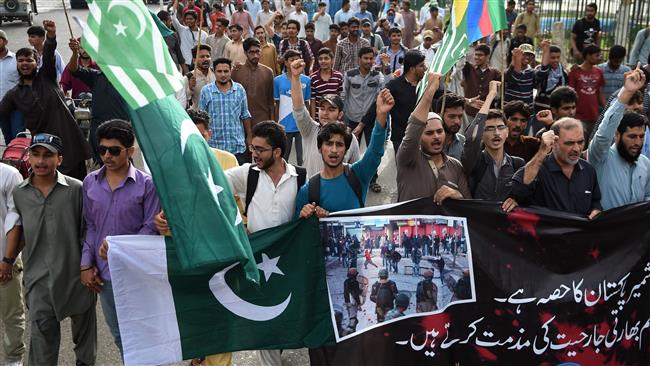 Supporters of Pakistan's Jamaat-e Islami party march at a rally to show solidarity with residents of the Indian-controlled Kashmir in Karachi