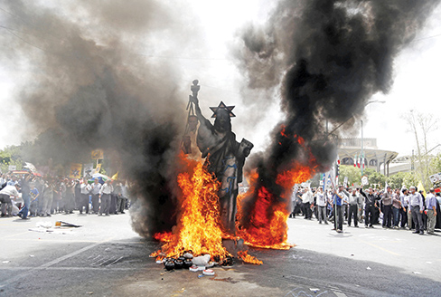 TOPSHOT- A statue depicting US Statue of Liberty decorated with a Star of David on its head is set ablaze by Iranian protestors during a parade marking al Quds Day in Tehran