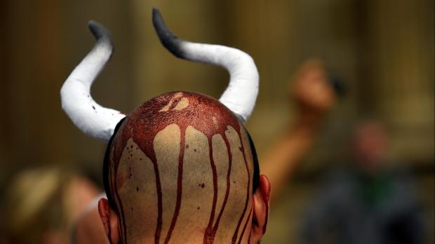 Half naked protesters are taking a stand against Spain's Running of the Bulls today