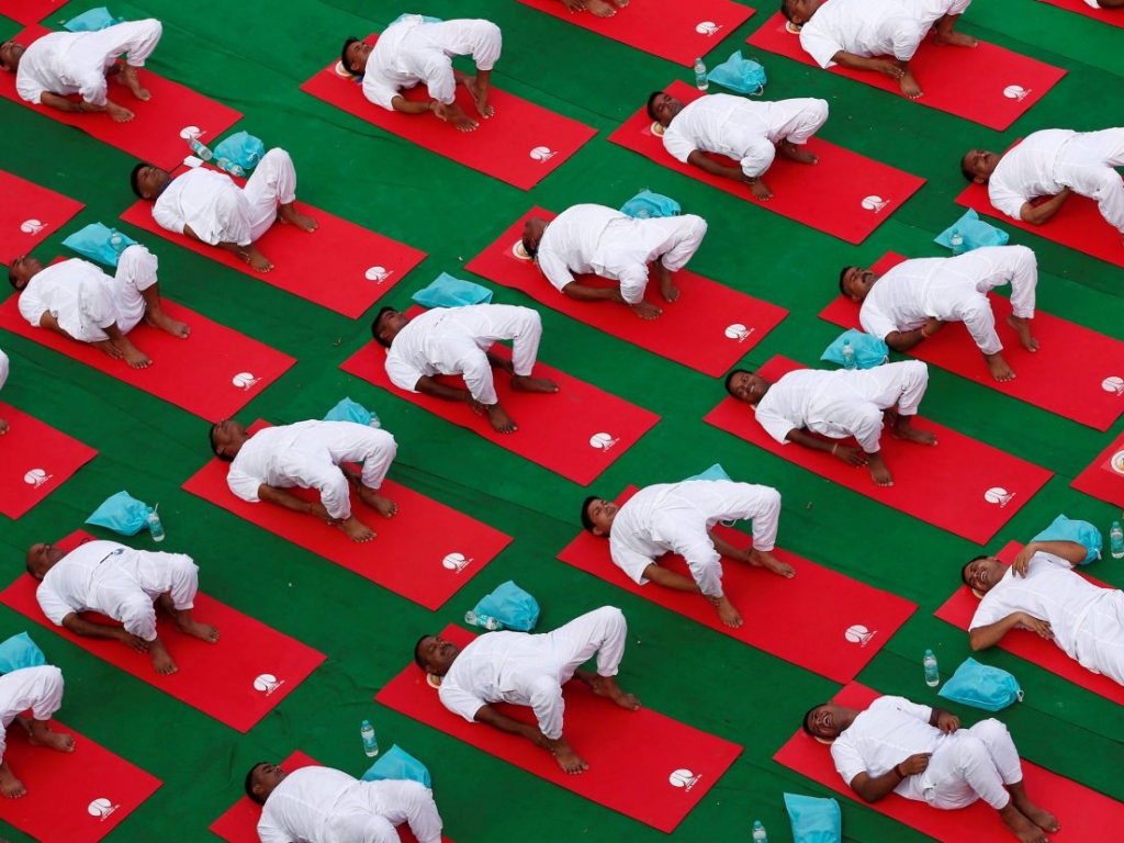 Participants perform yoga during World Yoga Day New Delhi India