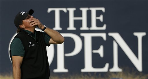 Phil Mickelson of the United States reacts as he narrowly misses a birdie putt on the 18th green during the first round of the British Open Golf Championships at the Royal Troon Golf Club in Troon Scotland Thursday