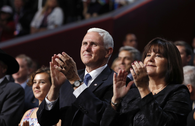 Indiana Gov. Mike Pence his wife Karen and daughter Charlotte left applaud during the second day session of the Republican National Convention in Clevelan