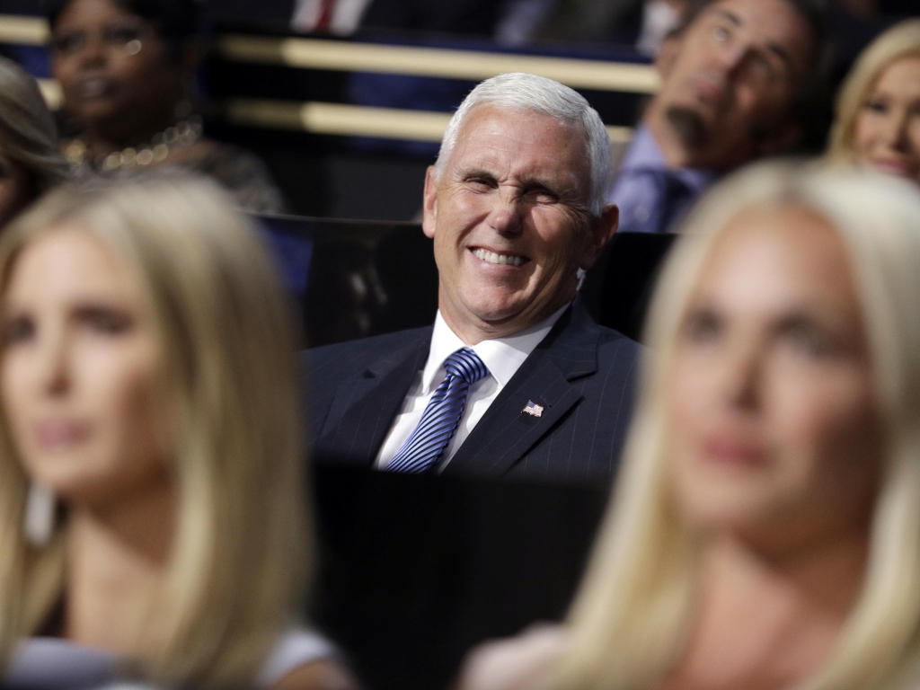 Vice Presidential nominee Gov. Mike Pence of Indiana smiles as he sits during the second day session of the Republican National Convention in Cleveland on Tuesday