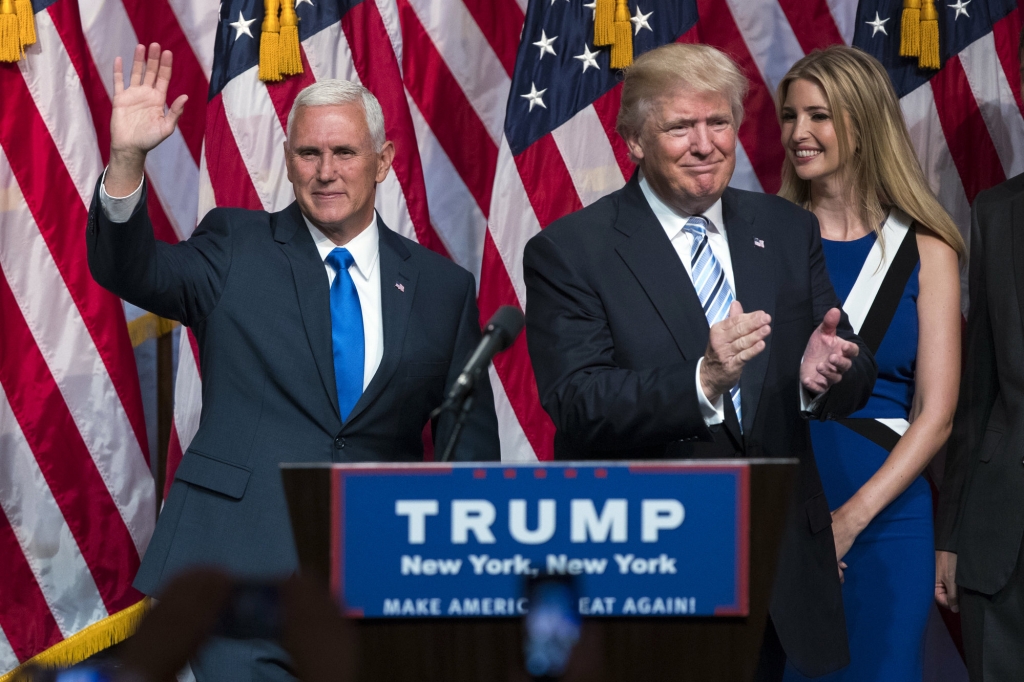 Republican presidential candidate Donald Trump right applauds Gov. Mike Pence R-Ind. left during a campaign event to announce Pence as the vice presidential running mate on Saturday