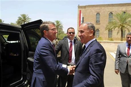 Visiting U.S. Defense Secretary Ash Carter left shakes hands with Iraqi Defense Minister Khaled al Obeidi at the Ministry of Defense Baghdad Iraq Monday