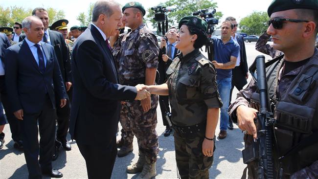 Turkish President Recep Tayyip Erdogan shaking hands with a guard during his visit to the Police Special Operation Department's Headquarters in Golbasi district of Ankara