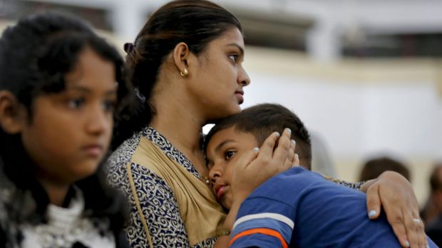 People attend a mass in memory of the victims of the attack on Holey Artisan Bakery in Dhaka Bangladesh