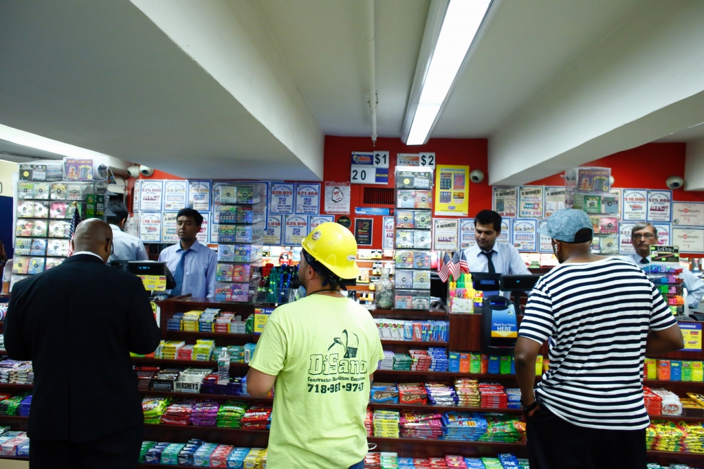 People buy lottery tickets at a store in Penn Satation