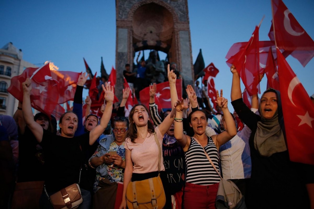 People chant slogans as they gather at a pro-government rally in central Istanbul's Taksim square Saturday