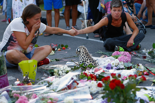 People paid tribute to attack victims Saturday in Nice France. Click