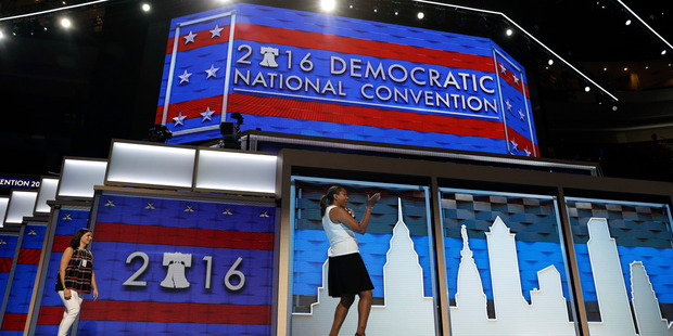 People stand on stage during setup before the 2016 Democratic Convention