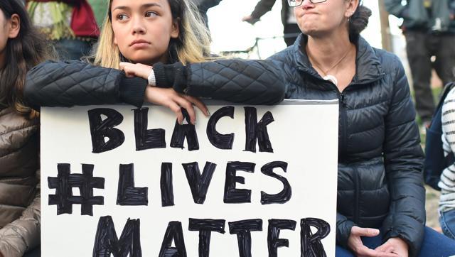 People take part in a rally for the Black Lives Matter movement at Justin Herman Plaza in San Francisco