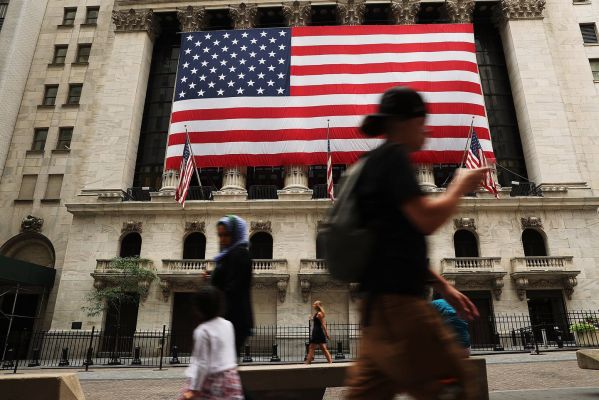 People walk by the New York Stock Exchange